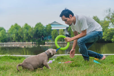 Young woman with dog on field