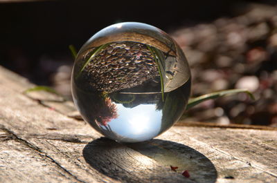 Close-up of crystal ball on wooden table