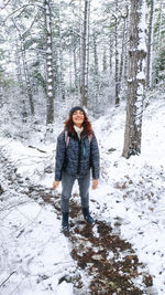 Full length portrait of woman in snow