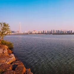 View of buildings in city at sunset