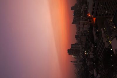 View of illuminated cityscape at sunset