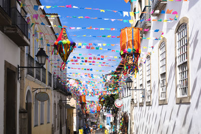 Colorful flags decorating buildings in city