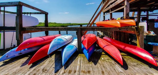 Close-up of multi colored flags on wooden table against sky