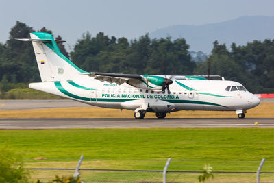 Airplane on airport runway against sky