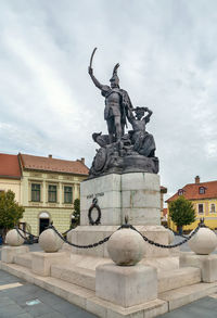 Statue of historic building against sky