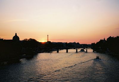 Panoramic view of people in city against sky during sunset