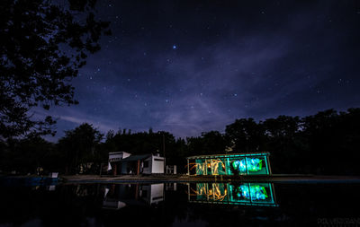 Illuminated built structure against sky at night