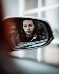 Portrait of a beautiful young woman in car