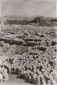 Scenic view of desert land against sky