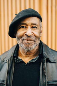 Portrait of man with flat cap against wall