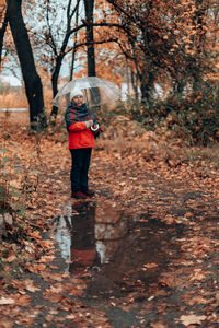 Full length of woman walking in forest