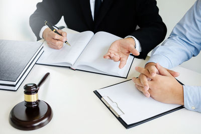 Midsection of man with text on table