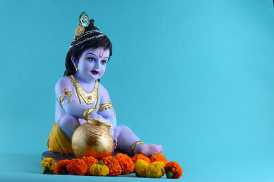 Statue of buddha against blue background