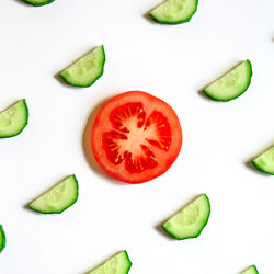 High angle view of chopped fruits over white background