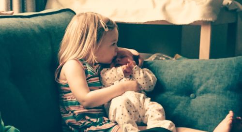 Girl sitting on sofa at home