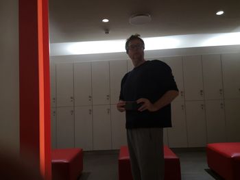 Full length of a young man standing in corridor