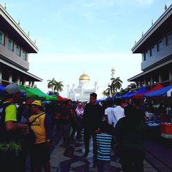 People in town square against sky