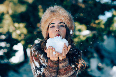 Portrait of woman with ice cream in winter