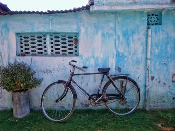 Bicycle parked against building