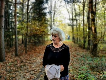 Woman standing in forest