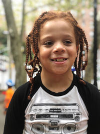 Smiling boy standing outdoors