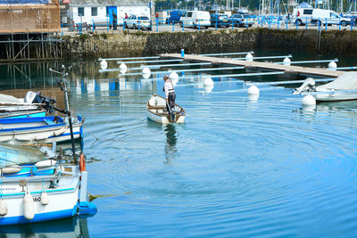 Man sitting on boat moored at shore