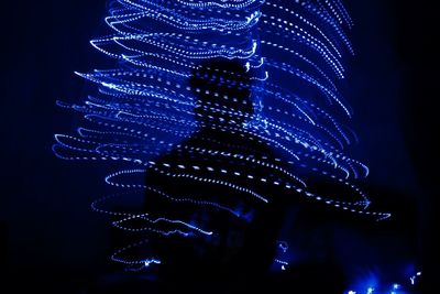 Low angle view of illuminated christmas tree at night
