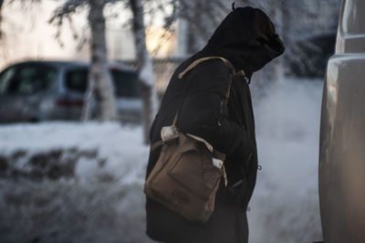 Rear view of man standing in snow