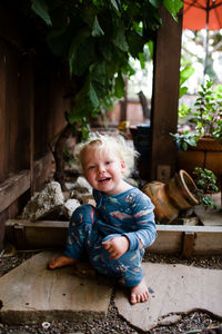 Portrait of cute girl sitting outdoors