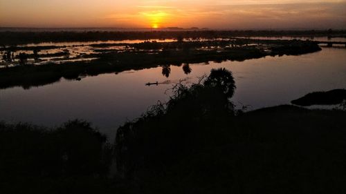 Scenic view of lake against sky during sunset