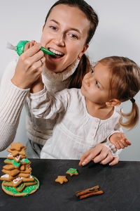 Close-up of mother playing with toy blocks on table