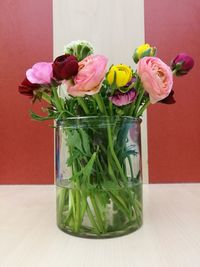 Close-up of pink roses in vase on table