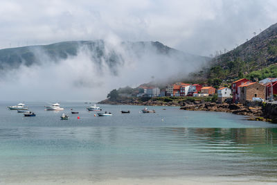 Panoramic shot of sea by buildings against sky