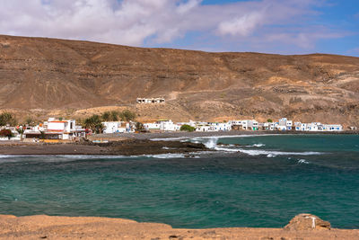 Scenic view of beach against cloudy sky