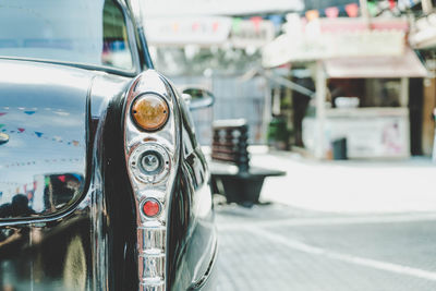 Close-up of vintage car on street