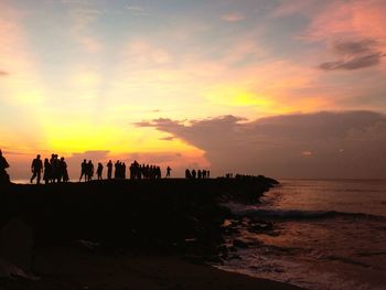 Silhouette of people standing on beach