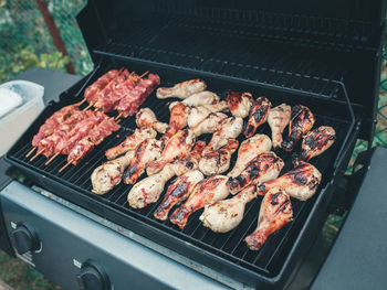 High angle view of meat on barbecue grill