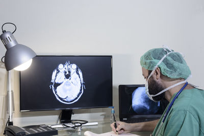 Doctor examining medical x-ray on computer at office