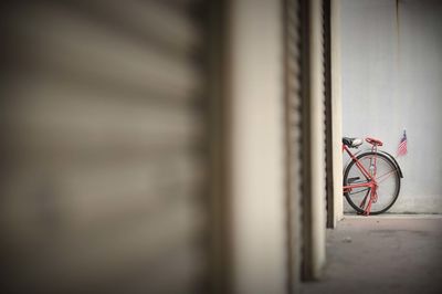 Bicycle leaning on wall of building