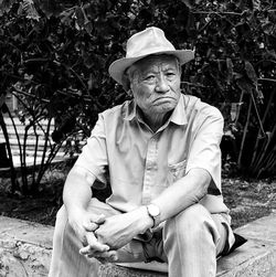 Portrait of a mature man sitting on tree