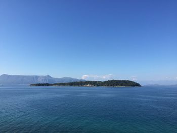 Scenic view of sea against blue sky