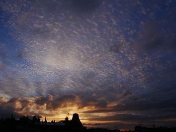 Low angle view of silhouette buildings against sky during sunset