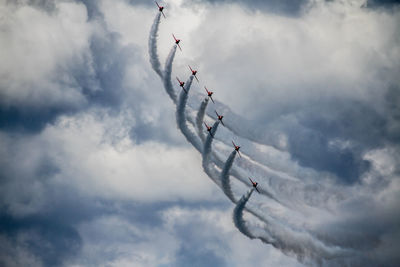 Low angle view of airshow against sky