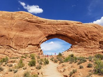 Scenic view of rock formations against cloudy sky