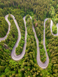 Winding road from high mountain pass, in summer time. aerial view by drone . romania