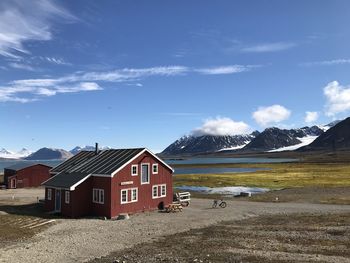 Houses by road amidst buildings against sky