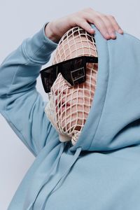 Man wearing mesh bag with sunglasses on face