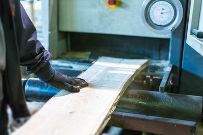 Midsection of man working on wood