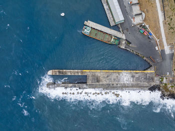 Bird's eye view of the harbour of stanley with a breakwater sea wall pier, tasmania, australia.