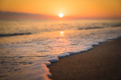 Close-up of sea against sky during sunset